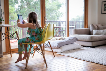 Young child using a tablet device at home