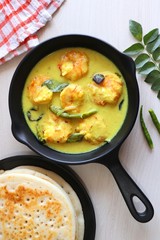 Yellow Prawns or Shrimp curry served with Amboli or Soft Dosa. Prawns cooked in coconut milk with mild spices. Prawns yellow Thai Curry. Goan fish Curry. Ingredients background with copy space. 