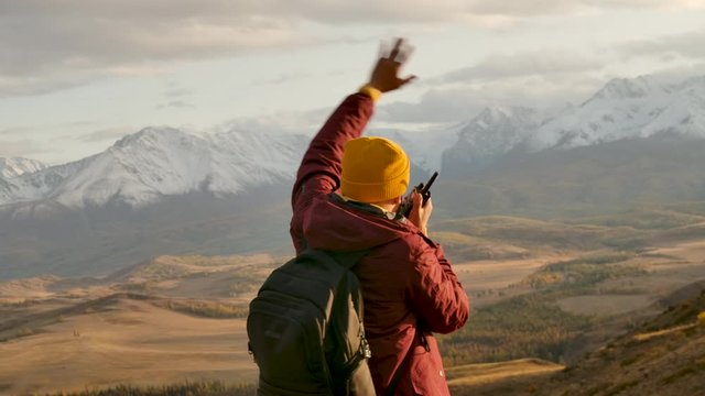 Unrecognized Male Human Moves Arms at Open Air National Park Mount Forest. Trailing Path Fascinating View. Traveling Person Communicating via Radioset on Ascet Summitting Active Voyage Backside Shoot