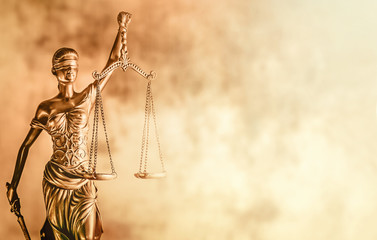 Scales of Justice brown background law concept image.