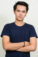 Portrait of young Asian man with arms crossed