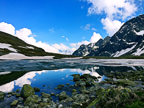 Scenic View Of Lake By Mountains Against Sky © min zou/EyeEm