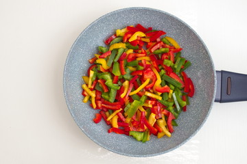 Directly above shot of colorful vegetables in a pan on white background