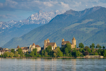 View of old city of Rapperswil dominated by its 13th century castle and the alps in the background, St. Gallen, Switzerland