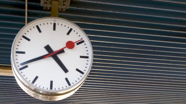 Side view of a big clock in a train station