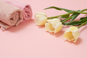 Soft terry towels with flowers on a pink background.