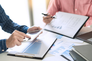 Business team working with plan on office desk with new startup project analyzing financial document data charts and graphs in Meeting and successful teamwork Concept.