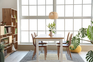 Interior of modern stylish dining room with floral decor