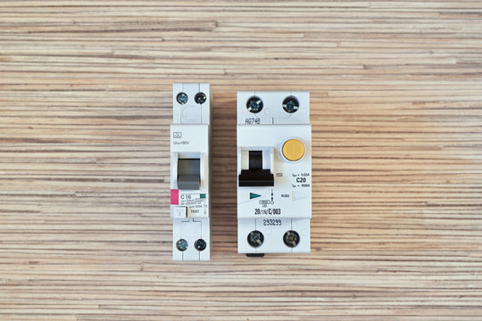Two electric differential circuit breakers in different versions, single-module and two-module. One narrow, the other wide. Compact version. Protection of a person from electric current.