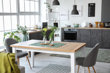 Interior of modern stylish dining room with floral decor