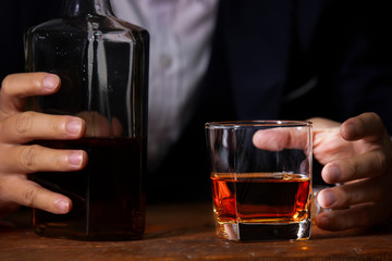 Closeup businessmen holding a glass of whiskey