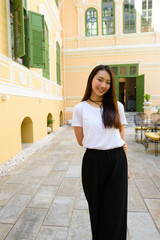 Young beautiful Asian woman at the coffee shop outdoors