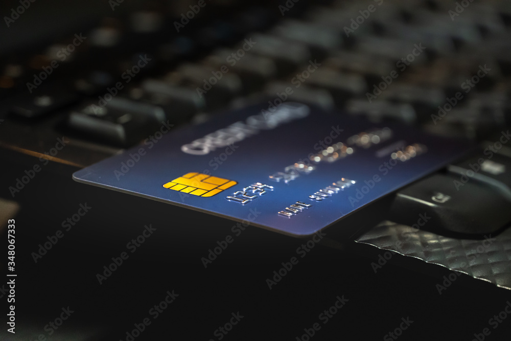 Poster Shallow focus Credit Card on Computer keyboard. Background for E-commerce and online shopping concept.