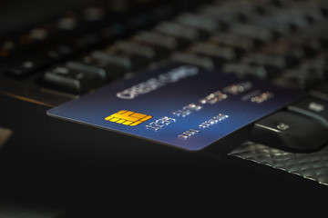 Shallow focus Credit Card on Computer keyboard. Background for E-commerce and online shopping concept.