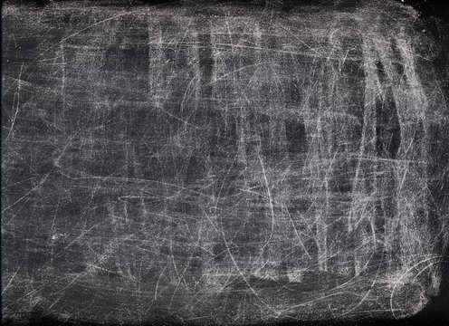 Scratched background. Weathered chalkboard. White dust on black copy space surface.