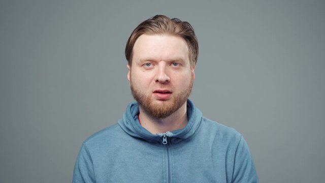 Video of sedative man in blue sweatshirt, closeup