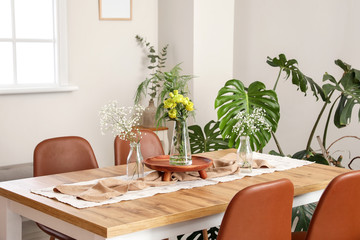 Interior of modern stylish dining room with floral decor