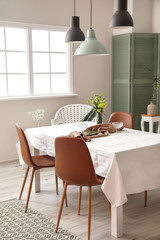 Interior of modern stylish dining room with floral decor
