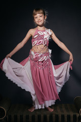A little girl dressed as an belly dancer