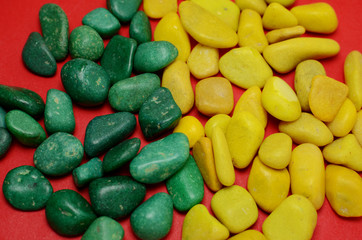 yellow and green pebbles on red background