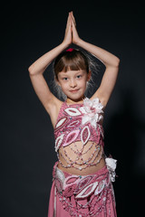 A little girl dressed as an belly dancer