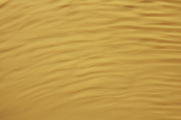 Yellow wavy striped background. Waves and ripples on the water. Place for text and design.