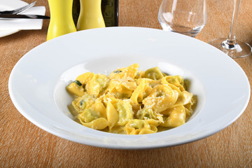 Tortellini with ricotta cheese and spinach, butter, sage sauce, grated parmesan. Parmigiano-Reggiano flakes