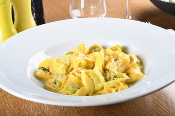Tortellini with ricotta cheese and spinach, butter, sage sauce, grated parmesan. Parmigiano-Reggiano flakes