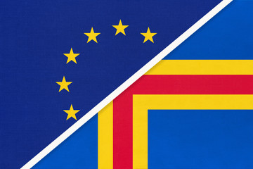 European Union or EU vs Aland Islands national flag from textile. Symbol of the Council of Europe association.
