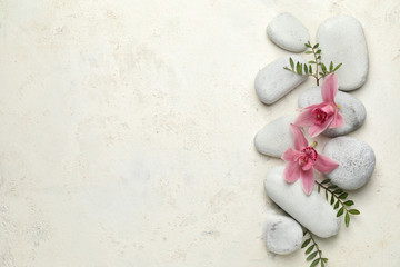 Beautiful composition with spa stones on light background