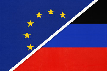 European Union or EU vs Donetsk Republic national flag from textile. Symbol of the Council of Europe association.