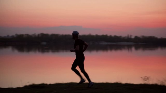 Runner Training In Sunset . Endurance Running Silhouette Exercise At Sunrise. Workout Jogger Exercise Before Run	