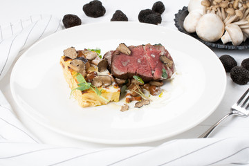 Truffle scented Beef Tenderloin, local truffle, gratin potatoes, sauteed wild mushrooms, cheese sauce