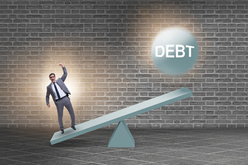 Debt and loan concept with businessman and seesaw