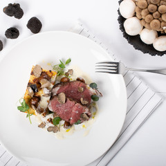 Truffle scented Beef Tenderloin, local truffle, gratin potatoes, sauteed wild mushrooms, cheese sauce