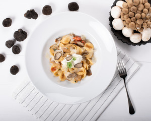 Orecchiette pasta with ceps, cherry tomatoes, ricotta gratin, fresh truffles and wild mushrooms