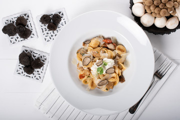 Orecchiette pasta with ceps, cherry tomatoes, ricotta gratin, fresh truffles and wild mushrooms