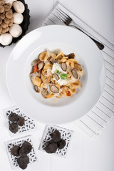 Orecchiette pasta with ceps, cherry tomatoes, ricotta gratin, fresh truffles and wild mushrooms