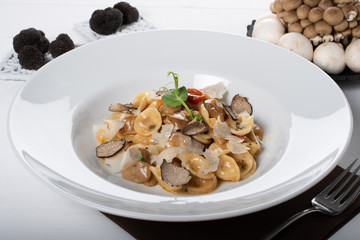 Orecchiette pasta with ceps, cherry tomatoes, ricotta gratin, fresh truffles and wild mushrooms