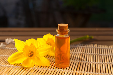 Essence of flowers  on white in beautiful glass jar
