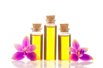 Essence of  orchid flowers on table in beautiful glass jar