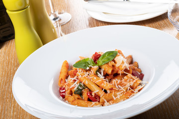 Pasta penne Napoli, traditional italian cuisine dish, chili, tomato and parmesan sauce