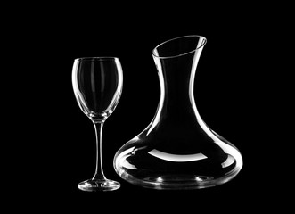 Empty decanter and glass on dark background