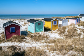 Fototapeta na wymiar Candy coloured beach hut on Skanor beach in Falsterbo, Skane, Sweden. Swedish tourism concept