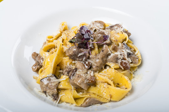 Fresh pappardelle pasta with porcini mushrooms and truffle scent. Parmesan and mozzarella cheese
