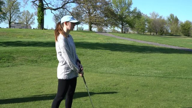 HD footage of woman at a golf course holding a golf club