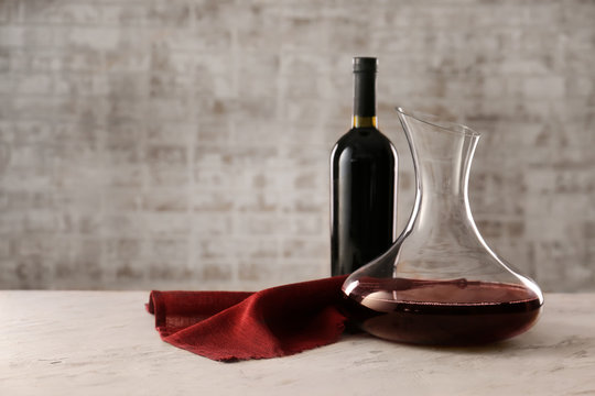 Decanter and bottle of wine on table