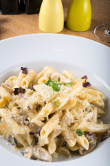 Prepared penne pasta with chicken and forest mushroom sauce, cheese with parmesan and mozzarella