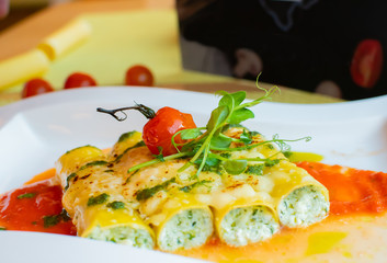 Cannelloni pasta tubes are stuffed with a rich and flavorful ricotta filling, then covered marinara