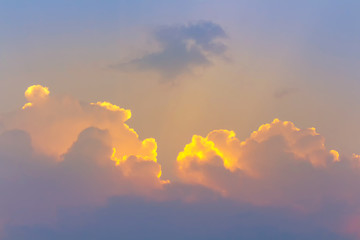 Bright orange in dim clouds in twilight sky